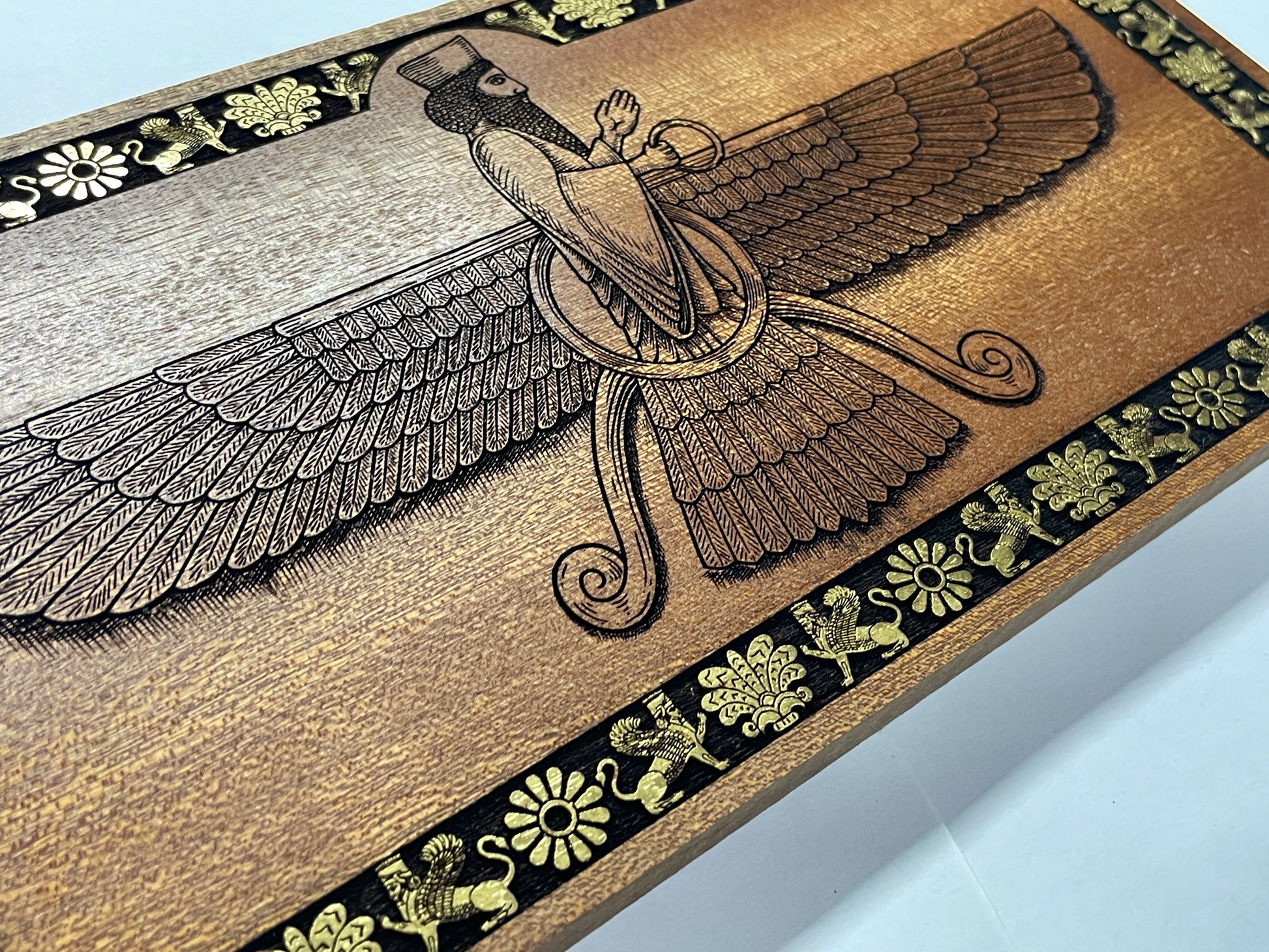 Hand engraved Ahura Mazda Faravahar wall art in mahogany wood, Persian Zoroastrian symbol decor with rich texture and carved details

