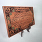 Occult alchemy decor board with zodiac coin symbols displayed on altar
