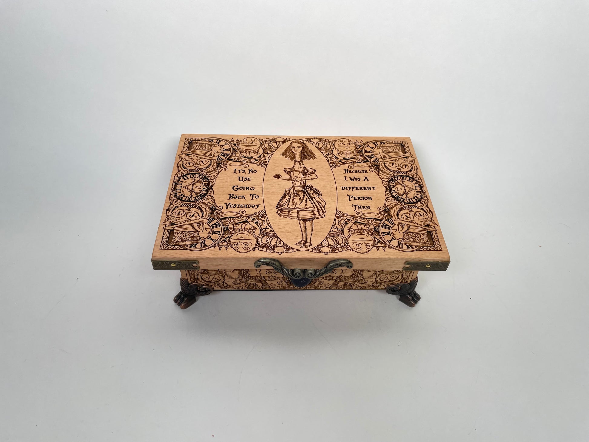 Close up of engraved Wonderland artwork on the lid of Alice in Wonderland box