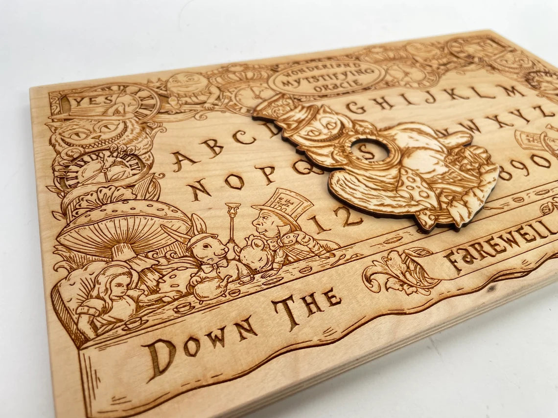 Flat wooden Ouija board with Alice Wonderland imagery displayed on tabletop

