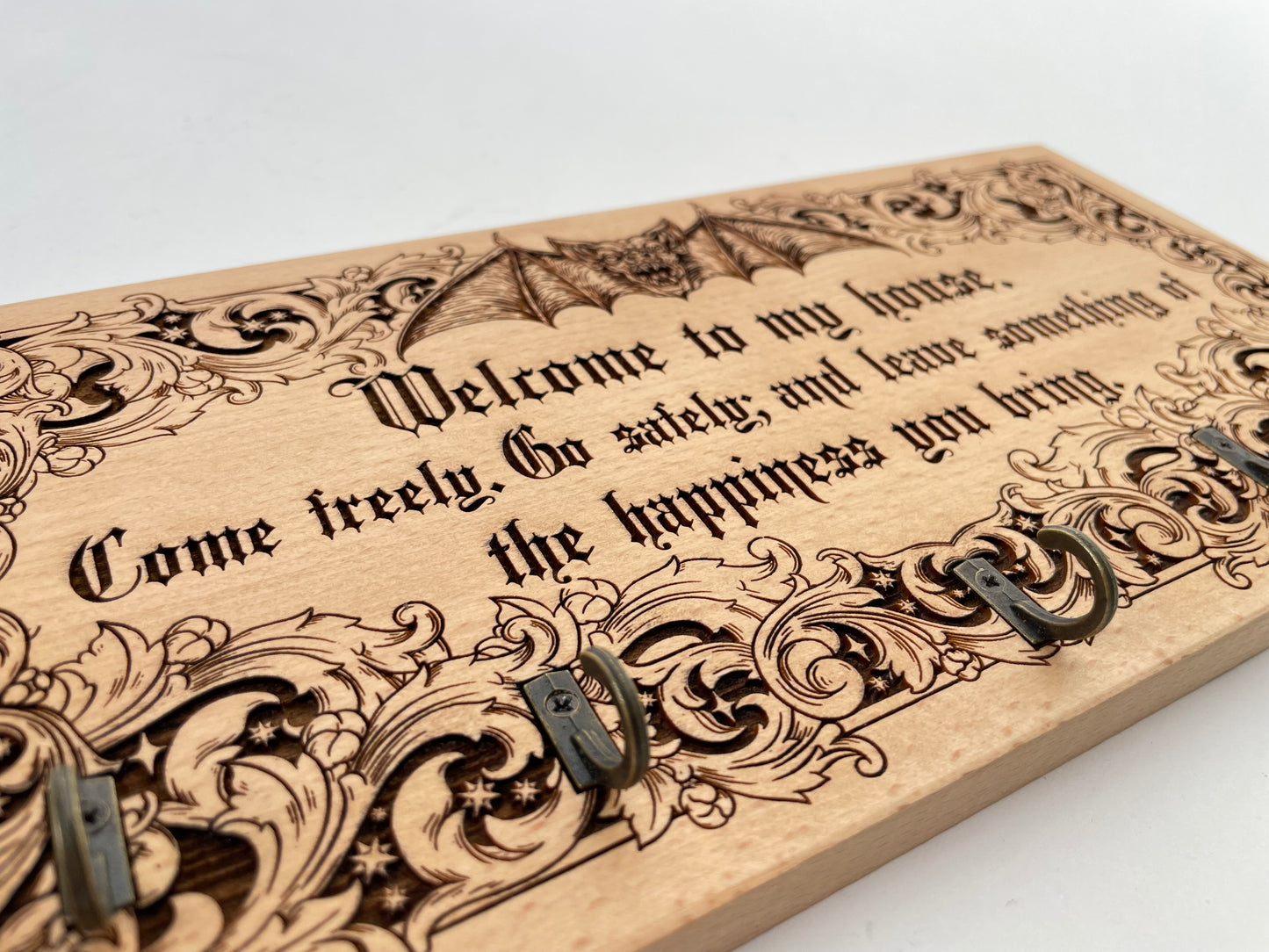 Wooden plaque with engraved Dracula quote and decorative elements on a white background
