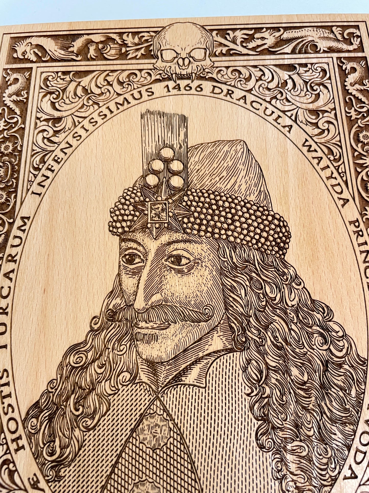 Close up of detailed engraving of Vlad the Impaler portrait on beech wood wall art gift idea 