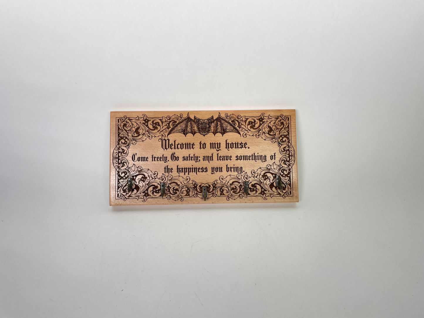 Welcome sign with decorative text and Dracula bat design on a white background