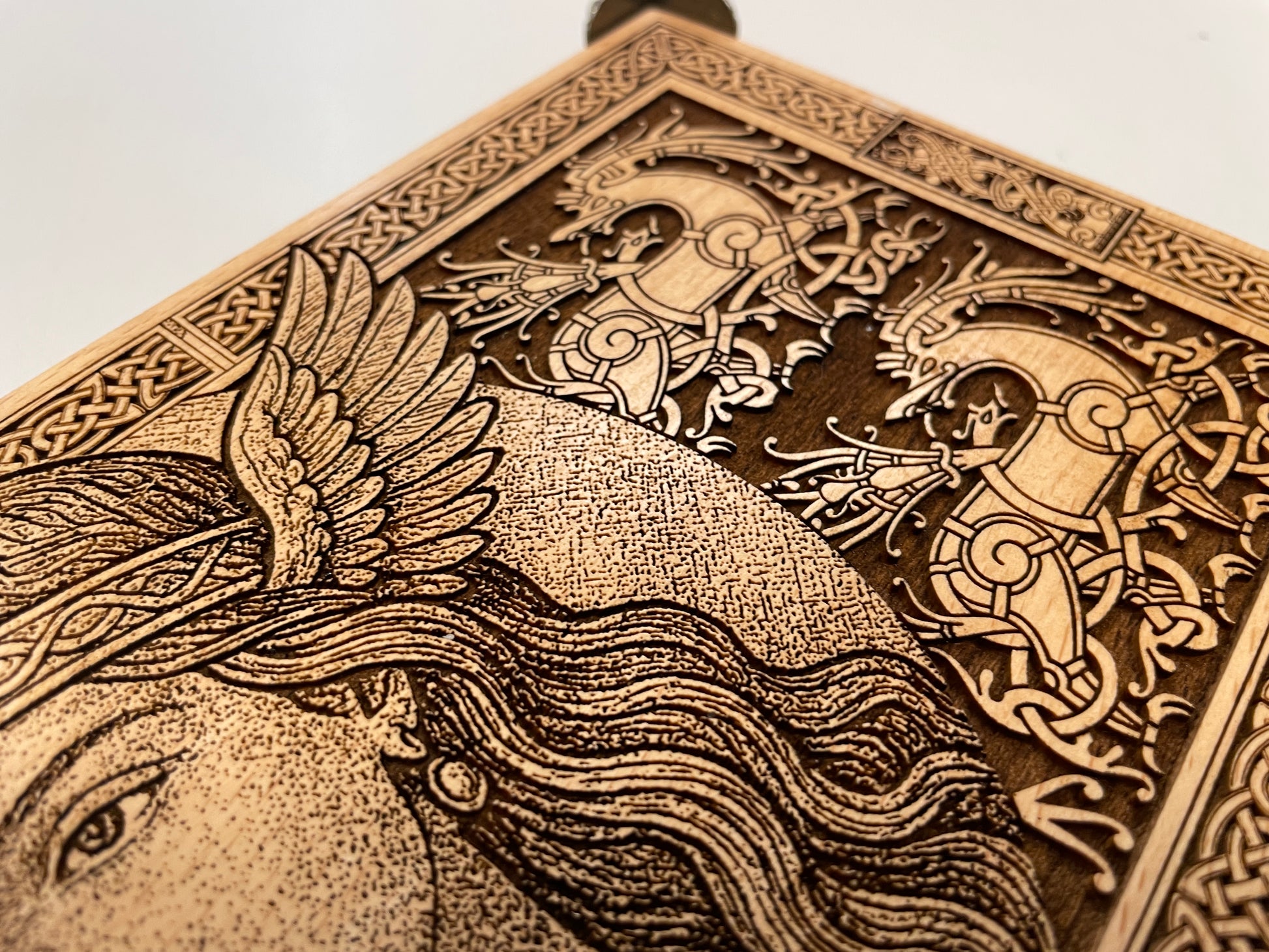 Close up details  of Freya Norse goddess engraving on wooden altar table
