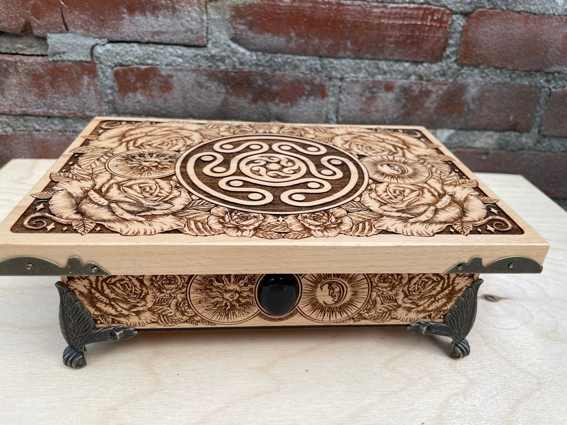 Close up of Hecate sigil engraving on wooden ritual storage chest
