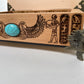 Wooden box with Egyptian-themed engraving and turquoise stone on a white background