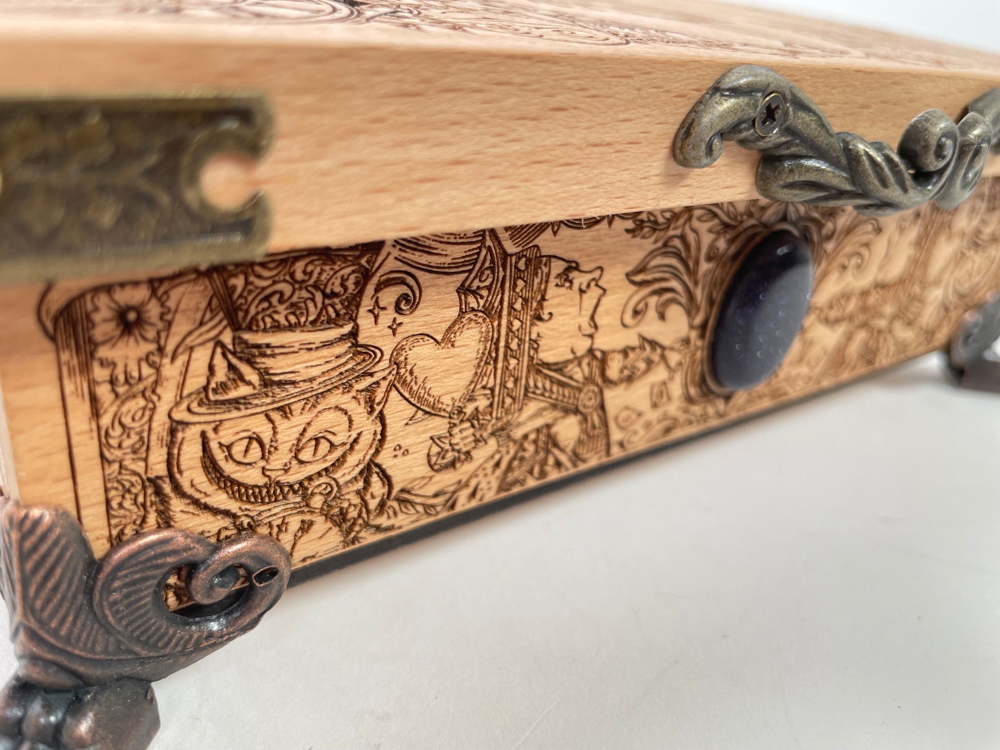 Close up of engraved Wonderland artwork on the lid of Alice in Wonderland box