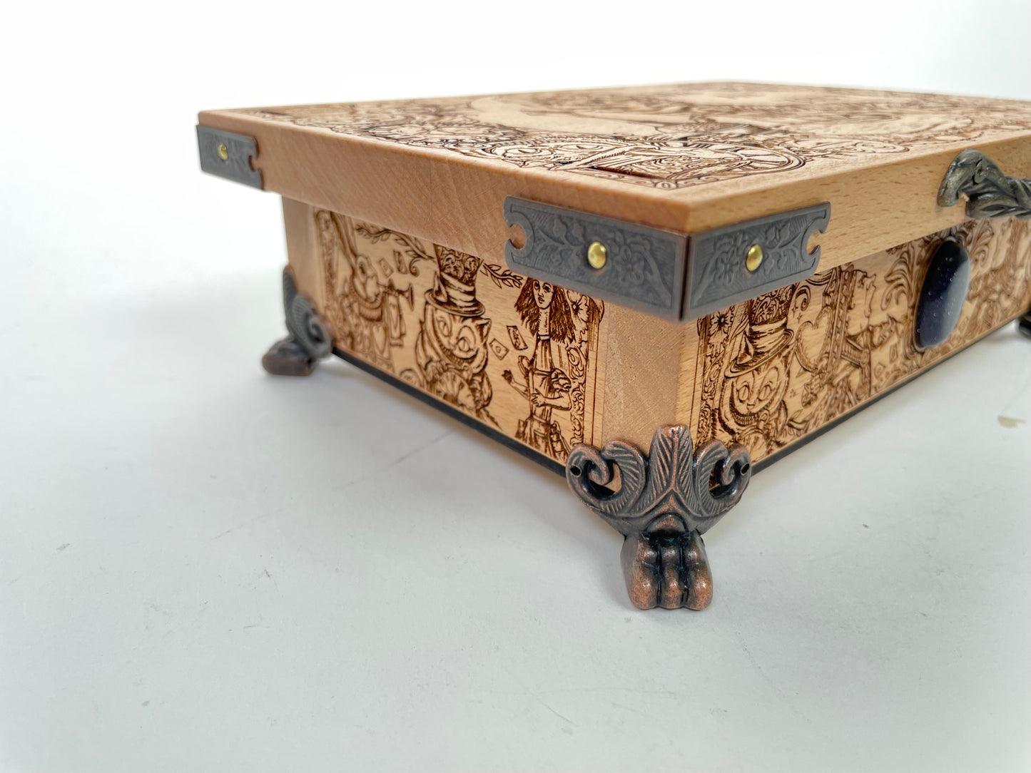 Wooden box with intricate carvings and metal accents on a white background