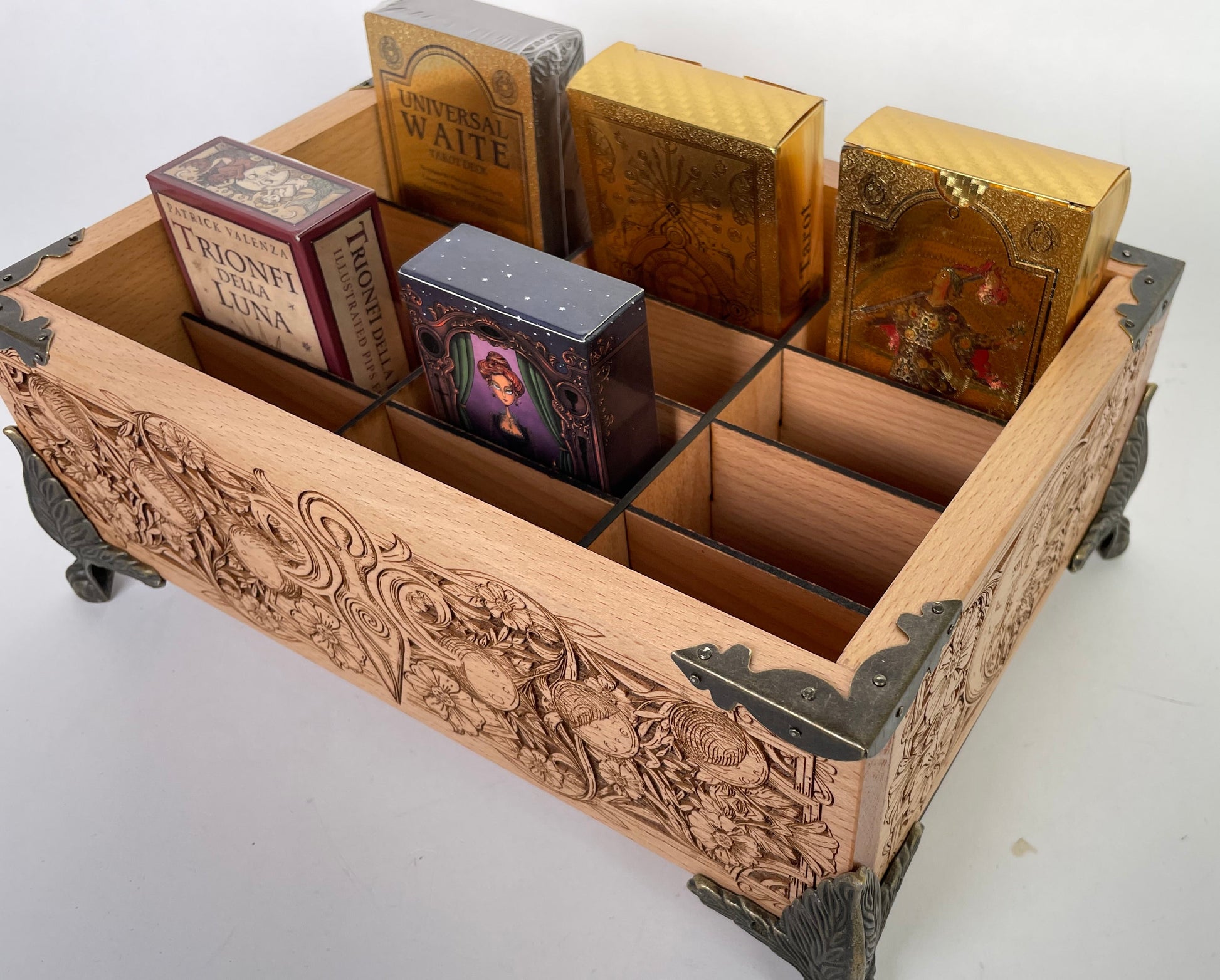 Wooden card organizer with compartments holding card packs on a white background