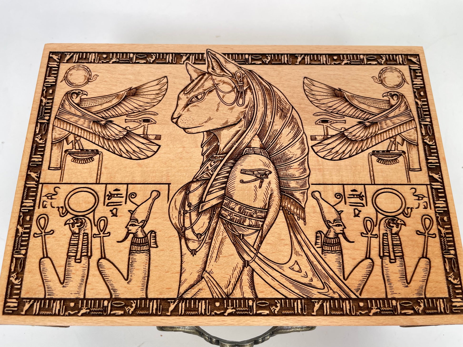 Close up of Egyptian hieroglyph  and Bastet engraving on altar table surface
