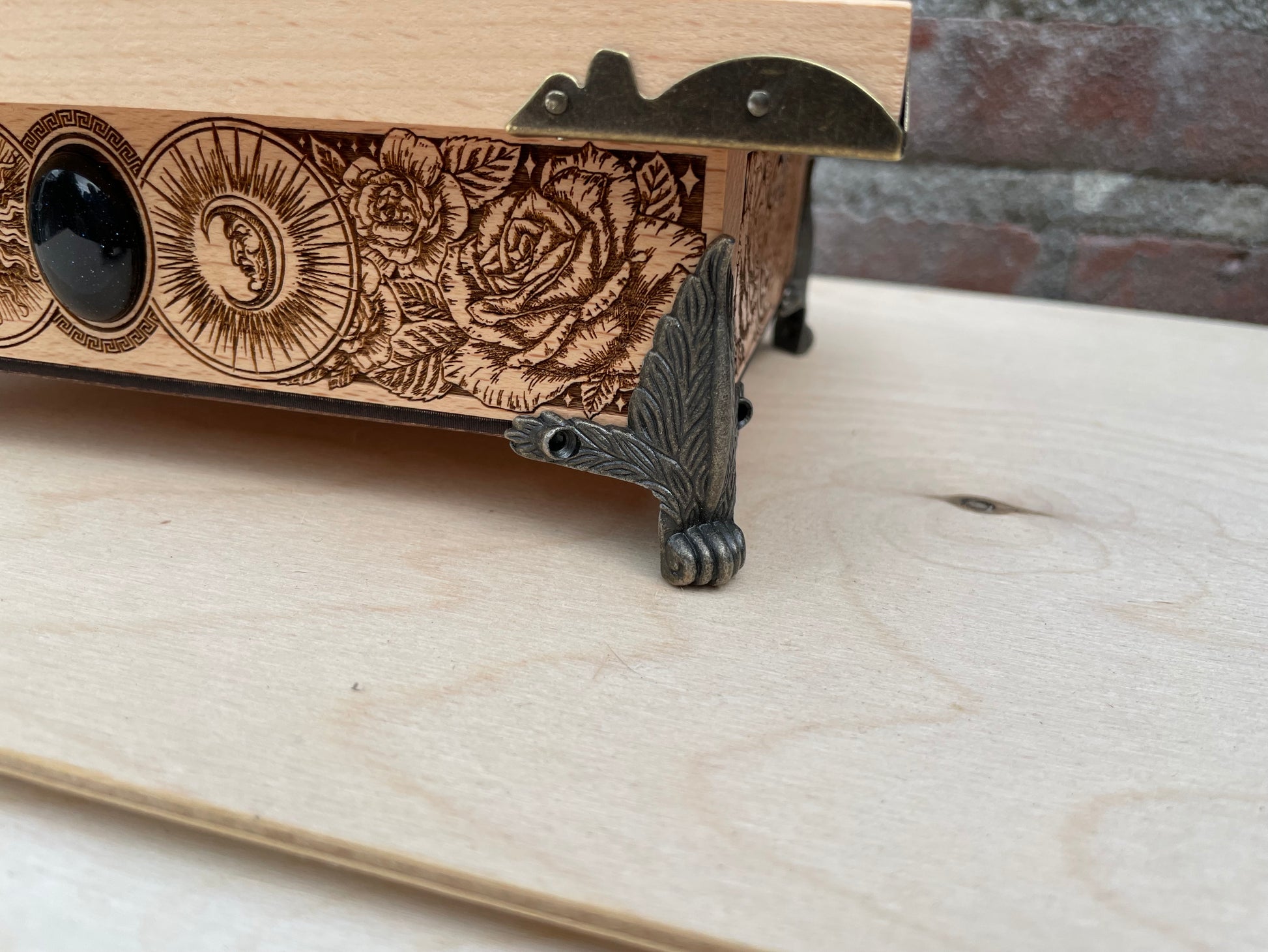 Close up of Hecate box engraving on wooden ritual storage chest
