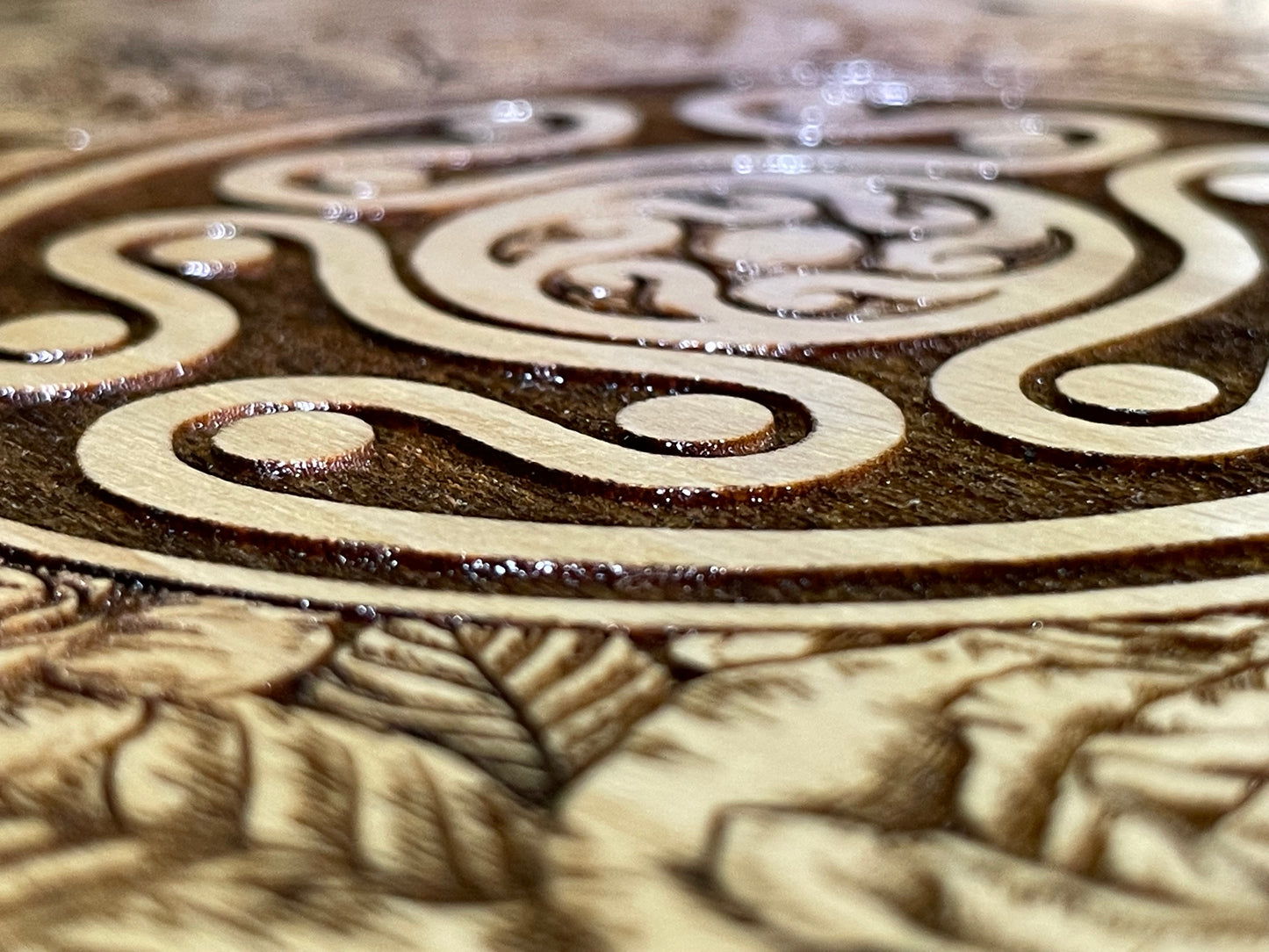 Close-up of Hekate sigil on wood surface.
