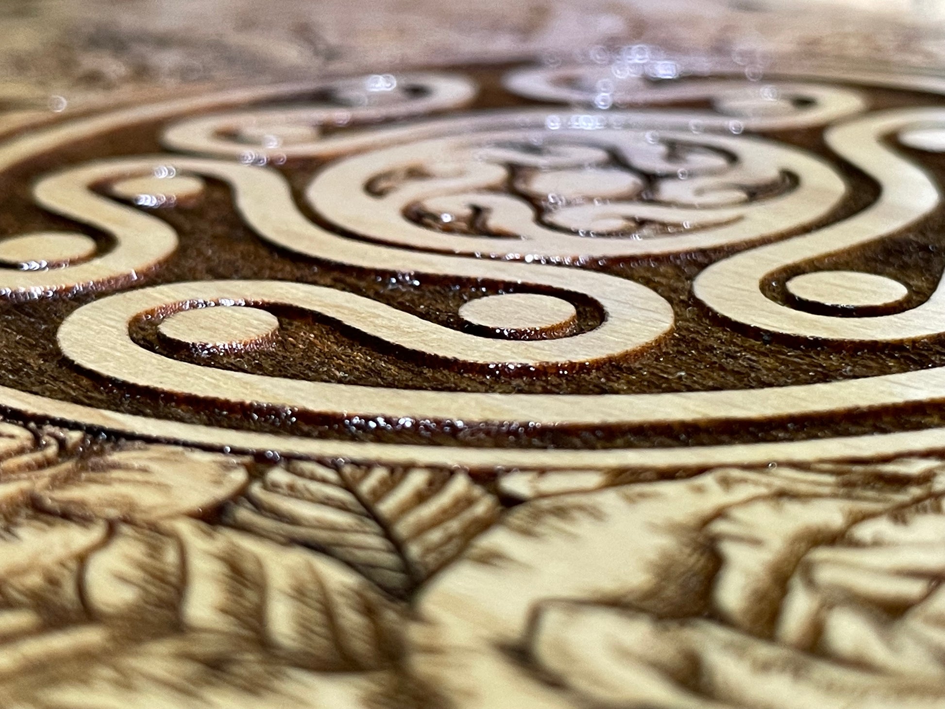 Close-up of Hekate sigil on wood surface.