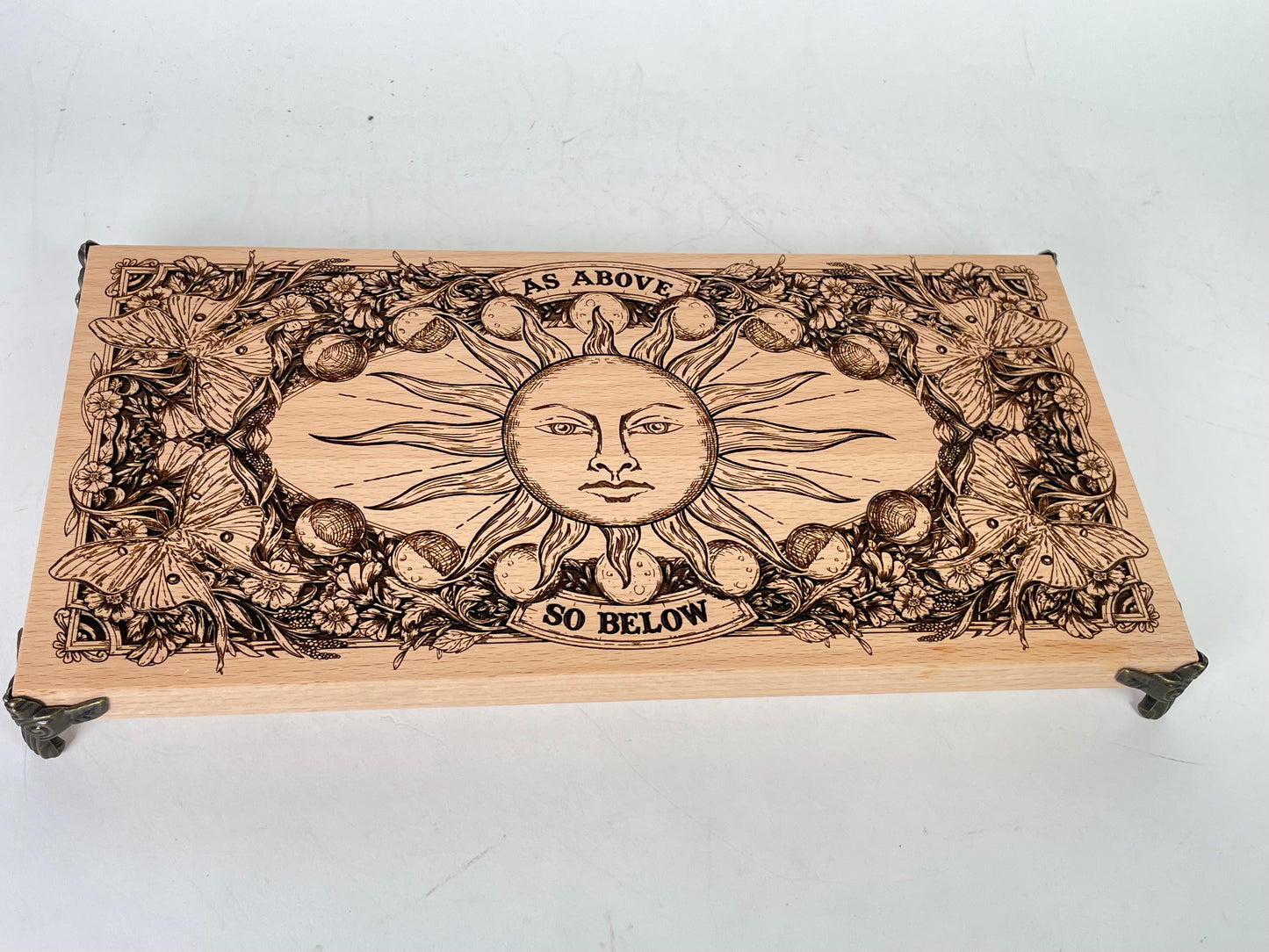 Wooden altar table with crystals, candles, and sacred tools placed on engraved board
