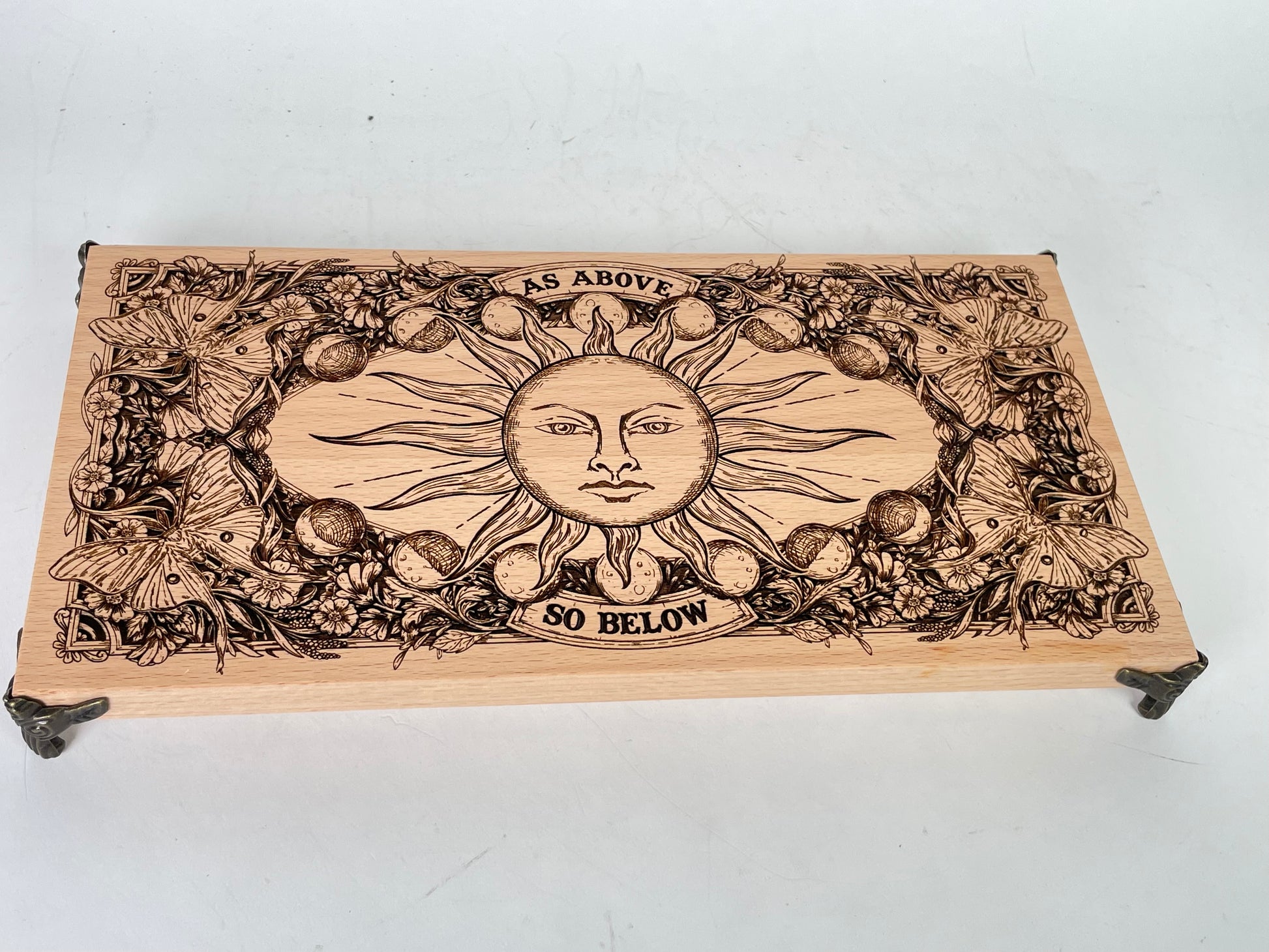 Wooden altar table with crystals, candles, and sacred tools placed on engraved board
