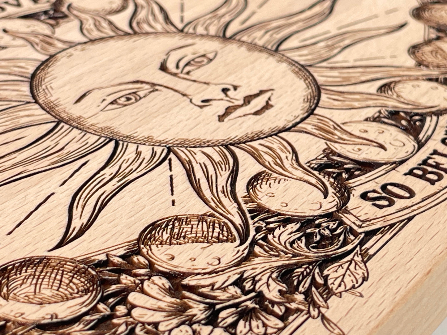 Close up of sun and Hermetic phrase engraving on wooden ritual altar board
