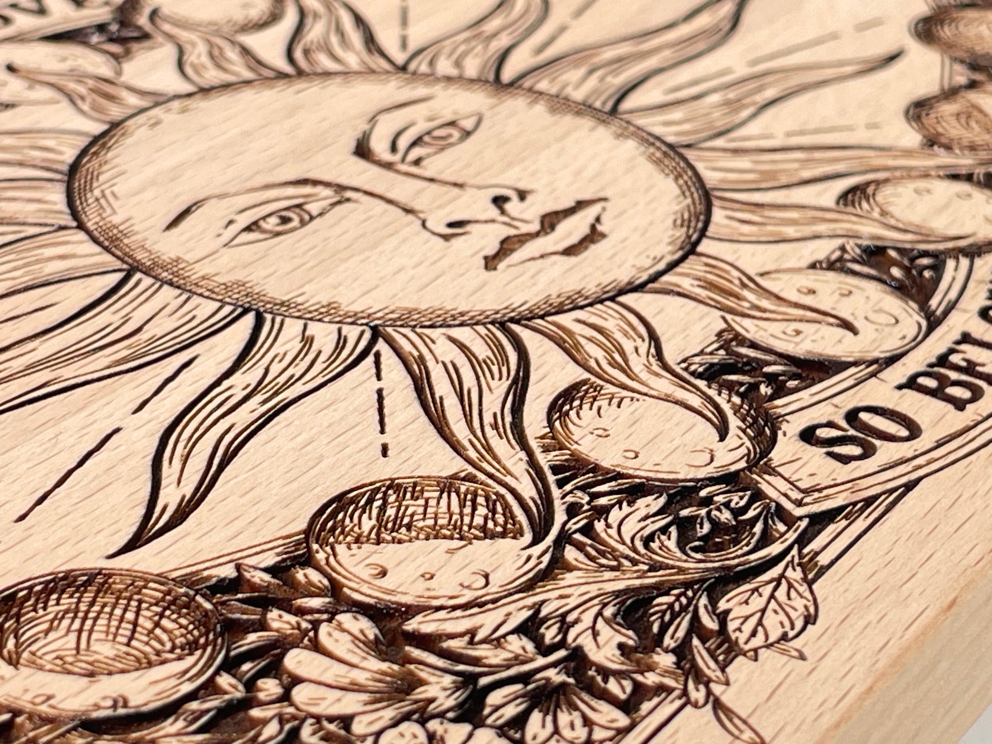 Close up of sun and Hermetic phrase engraving on wooden ritual altar board

