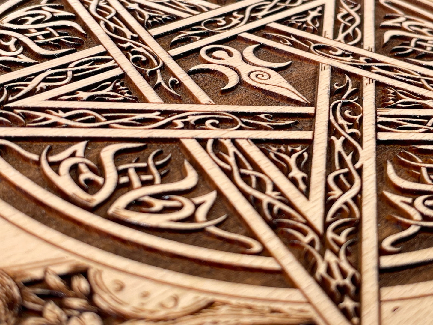 Close up of Celtic pentagram engraving on wooden ritual altar board
