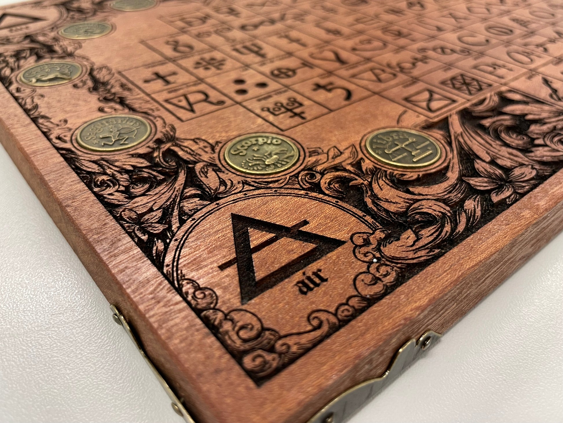 Wall decor with engraved  alchemy symbols and coins on a white background