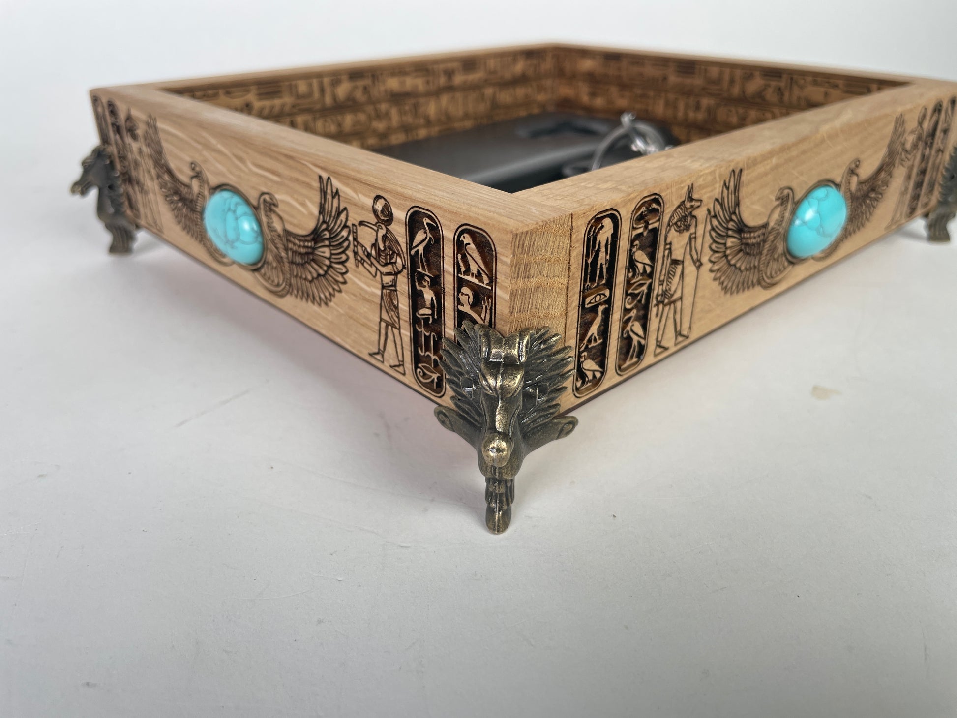 Close up of Egyptian hieroglyph engraving on solid oak valet tray
