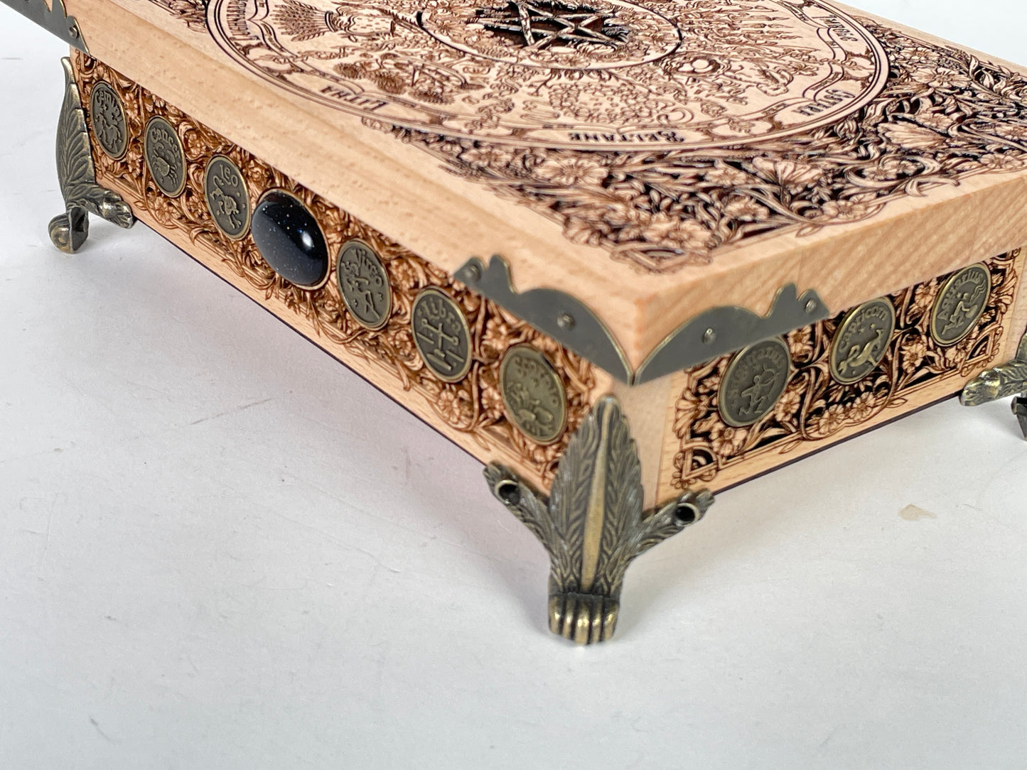 Close up of Wheel of the Year sabbat engraving on wooden altar table
