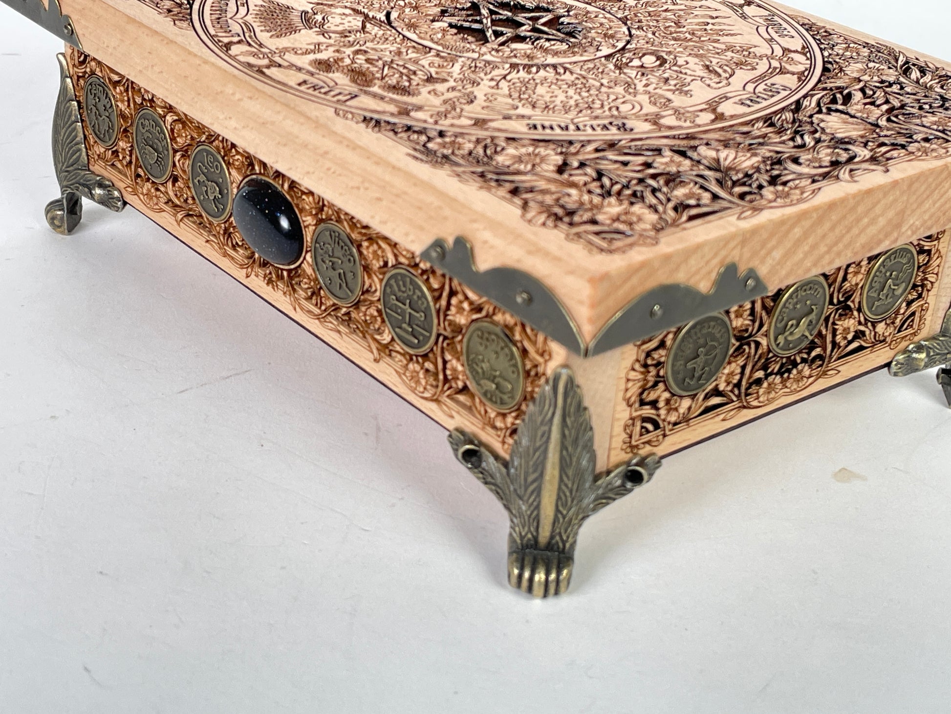 Close up of Wheel of the Year sabbat engraving on wooden altar table
