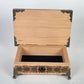Small wooden altar table with built in storage holding tarot decks and crystals
