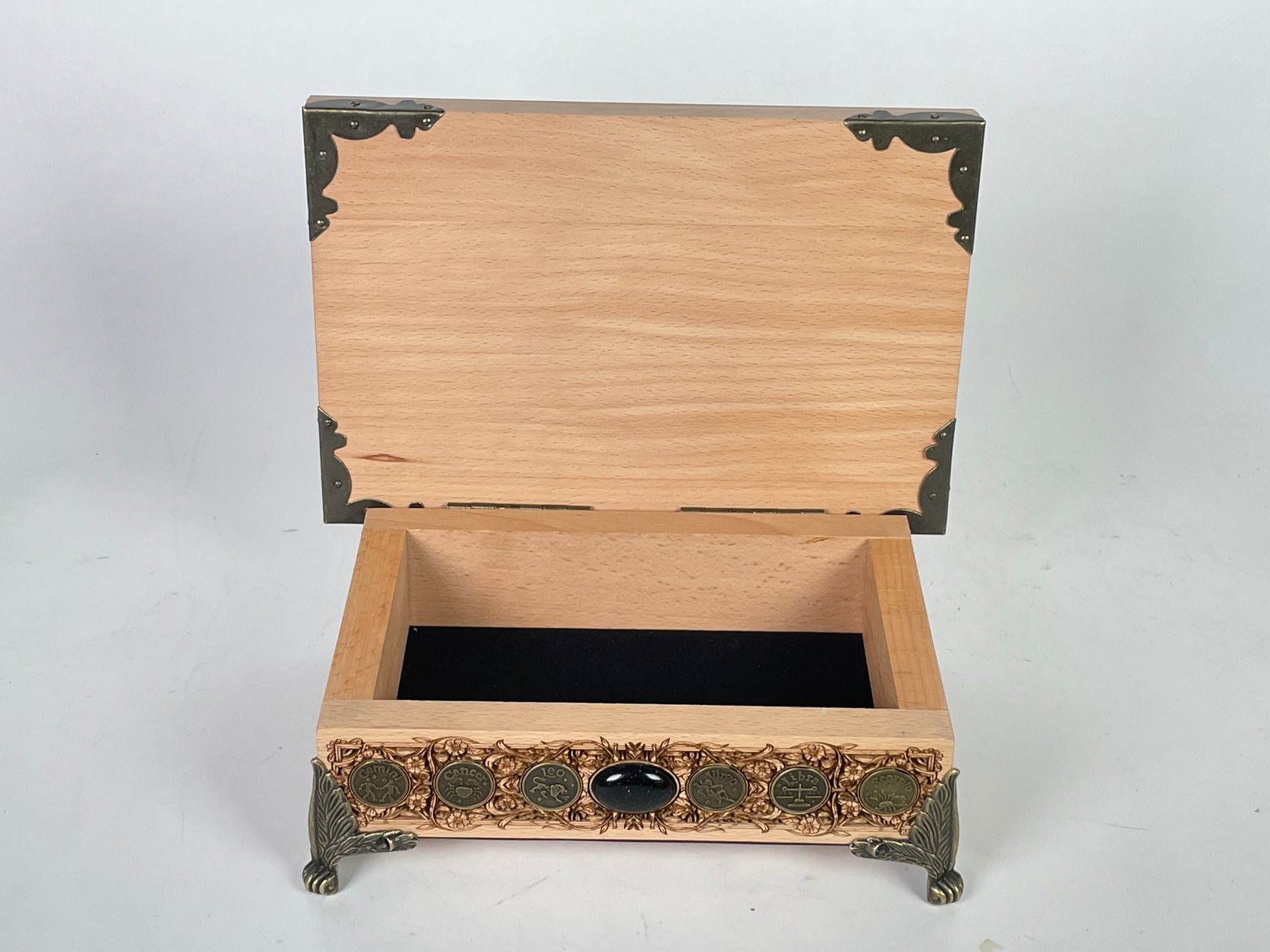 Small wooden altar table with built in storage holding tarot decks and crystals
