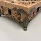 Wooden box with intricate carvings on a white background