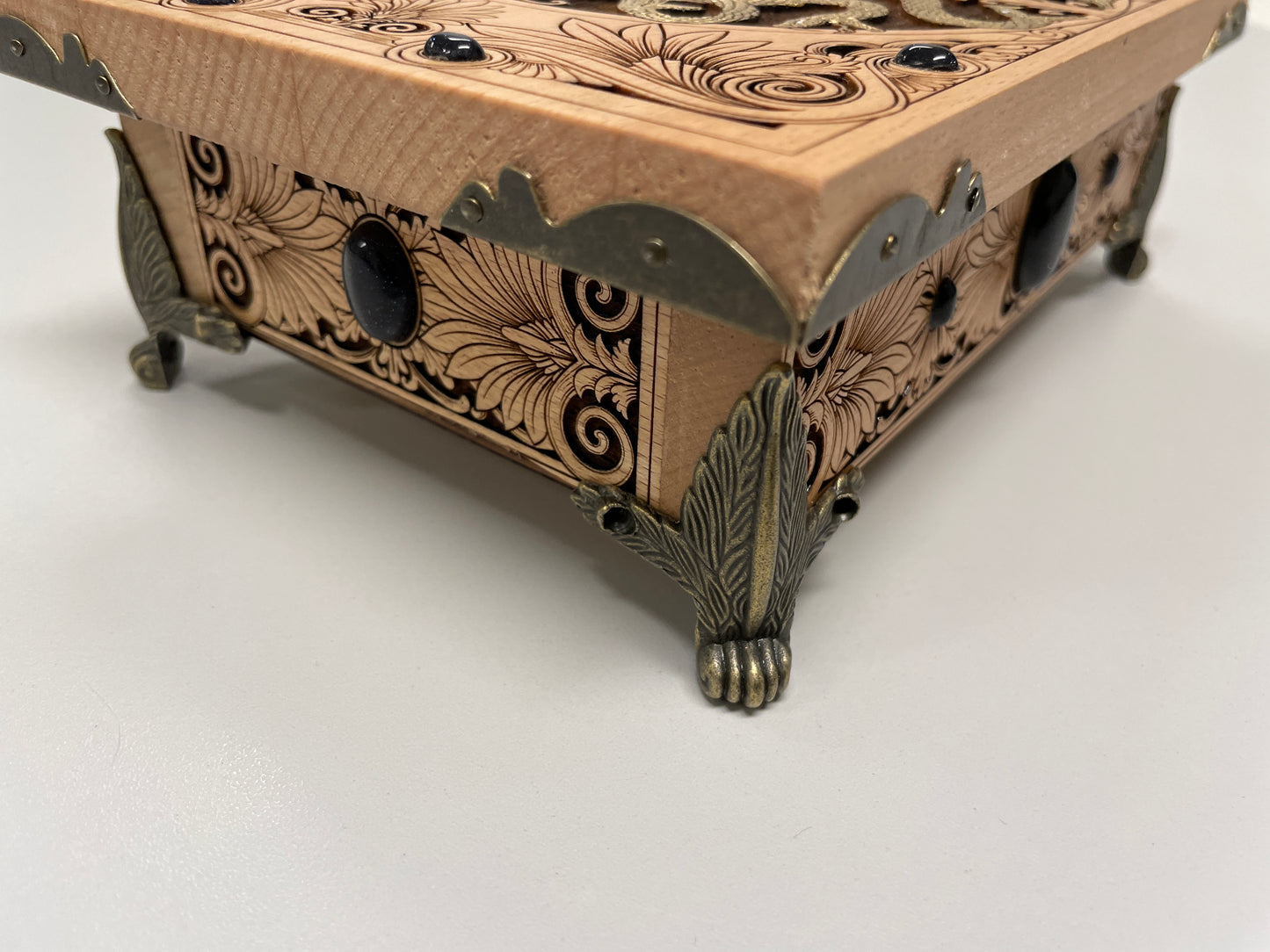 Wooden box with intricate carvings on a white background