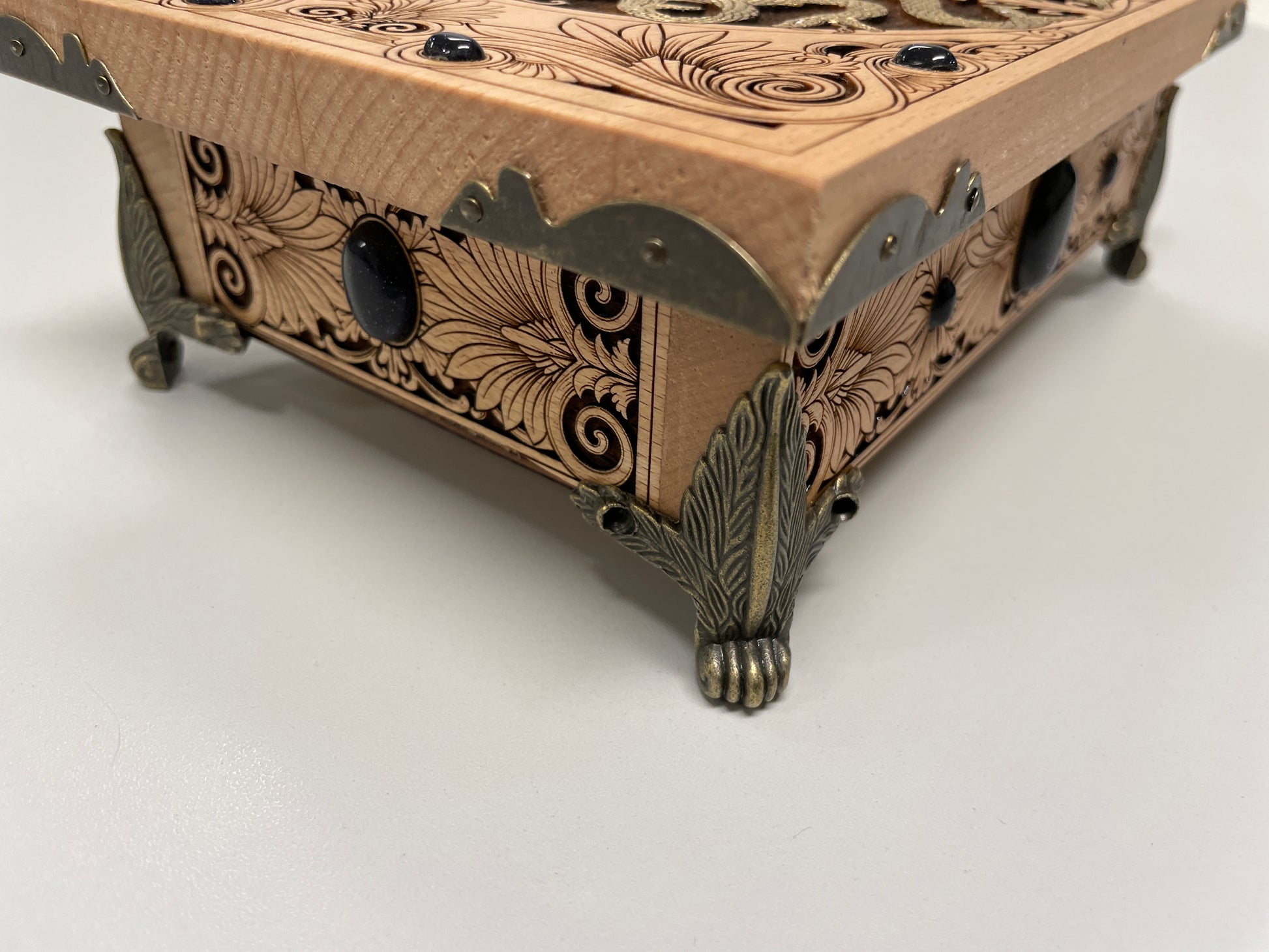 Wooden box with intricate carvings on a white background