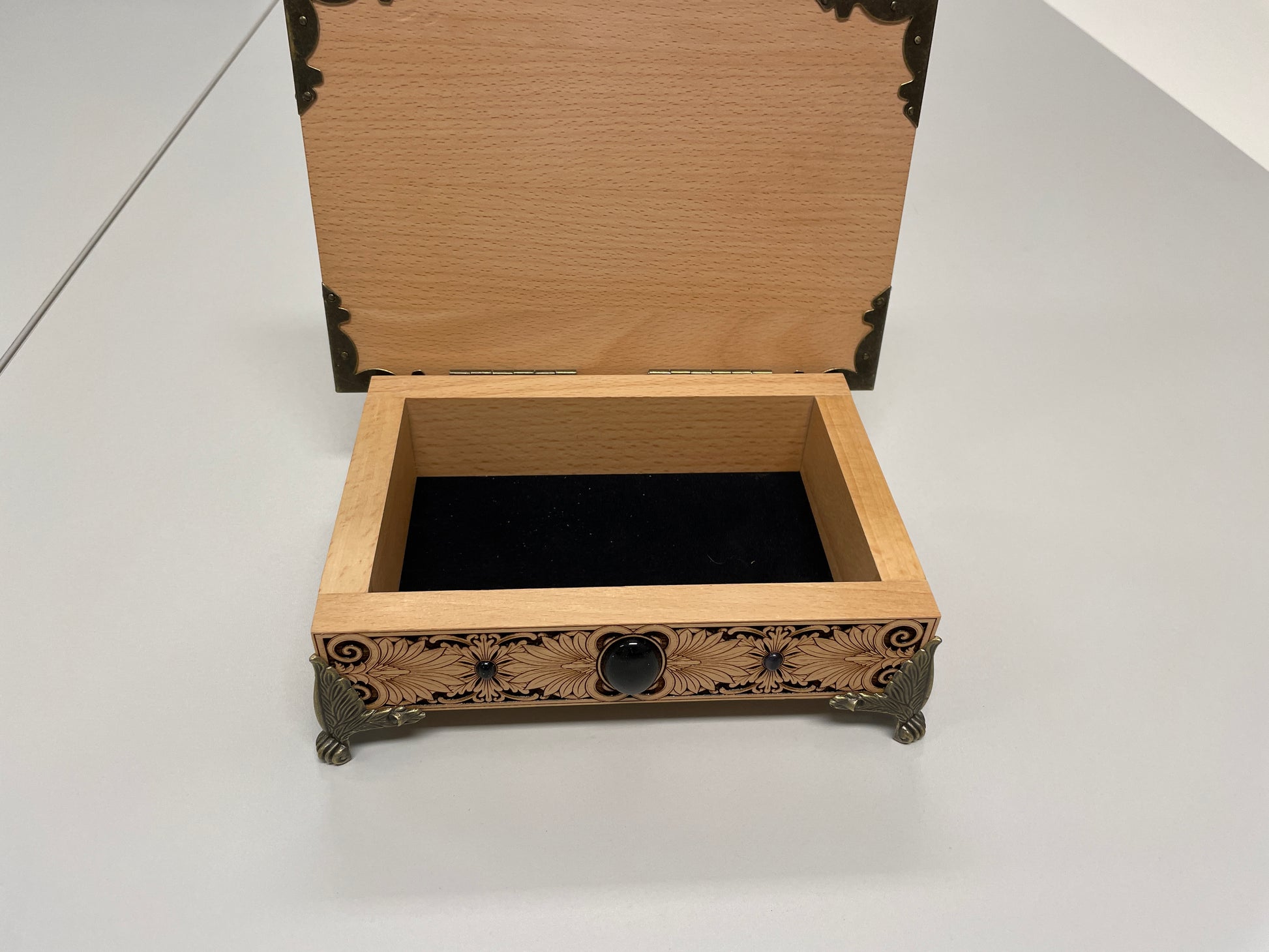 Wooden Medusa jewelry box with intricate carvings on a white background