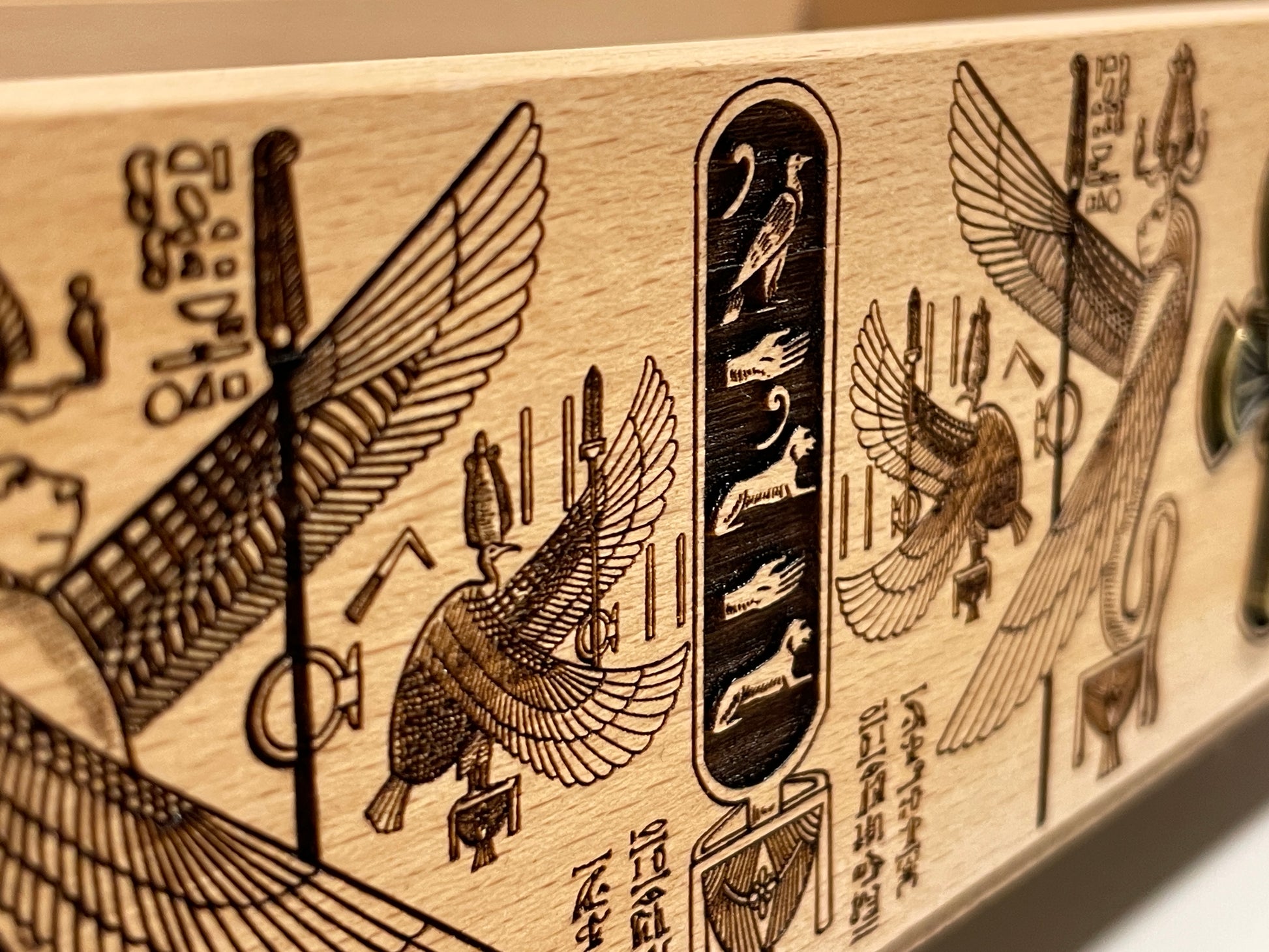 Side view of engraved Egyptian Book of the Dead tarot box showing wood grain and craftsmanship

