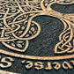 Close up of Tree of Life deep engraving with As Above So Below text on mahogany Wiccan ritual altar table
