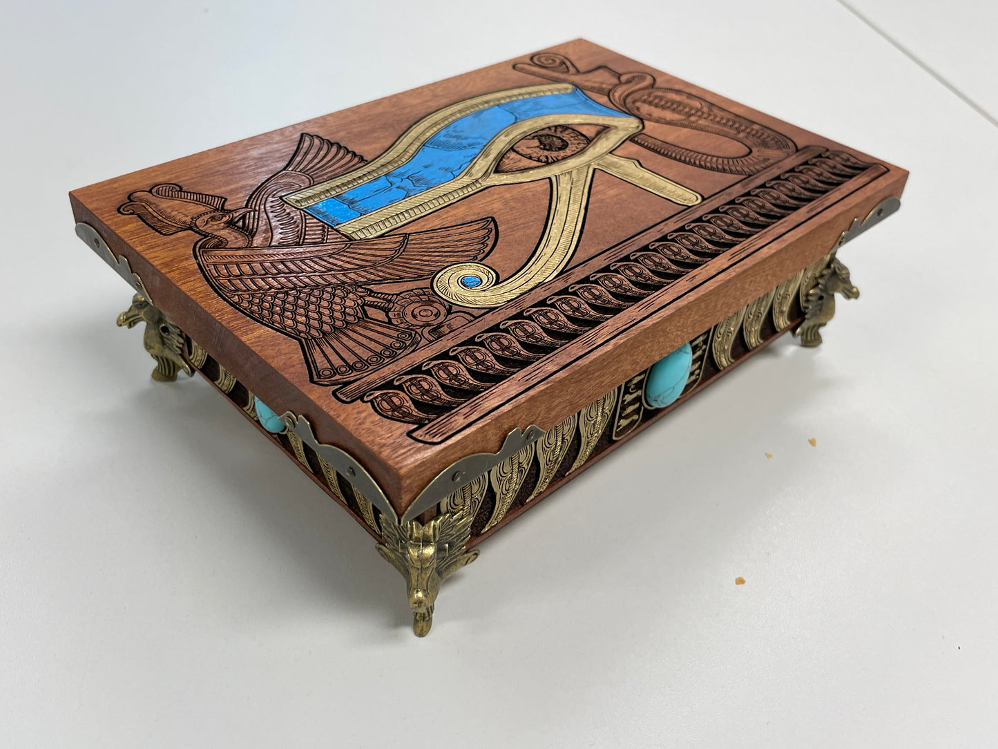Side view of engraved mahogany Eye of Horus wooden storage chest
