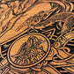 Close up of engraved Yggdrasil Tree of Life on mahogany wood with gold accents
