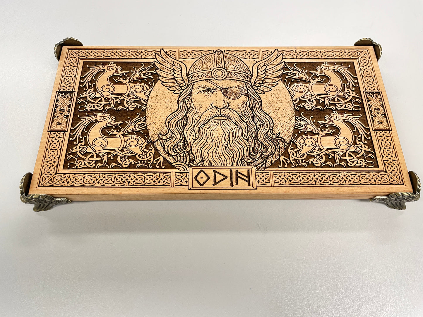 Close-up detail of engraved Odin figure on wooden Norse altar board
