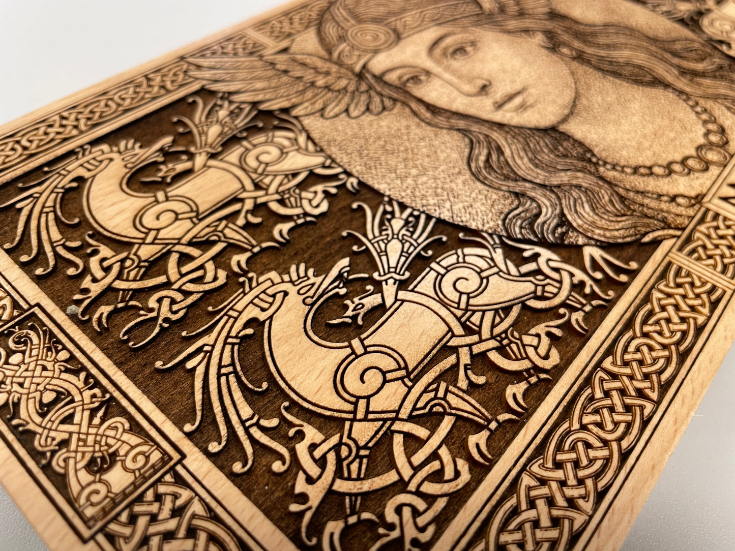 Close up of Freya Norse goddess engraving on wooden altar decor
