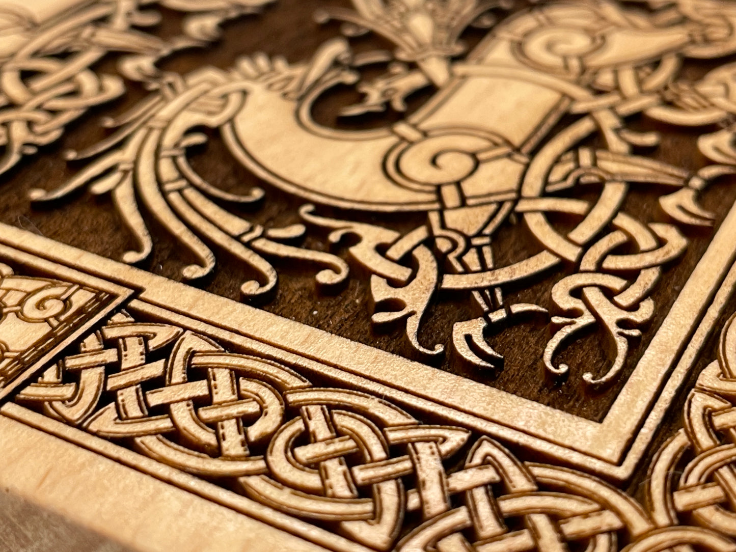 Close-up of intricate Celtic knot design on a wooden surface