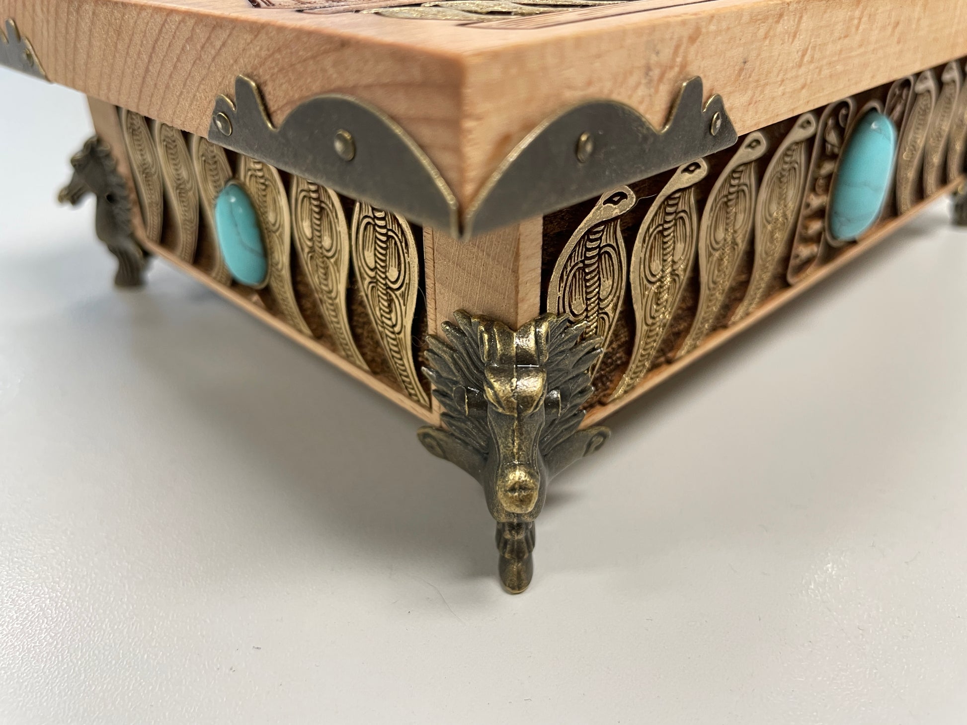 Detailed wood engraving of Eye of Horus altar box, Egyptian symbolism with winged deity and protective serpent border