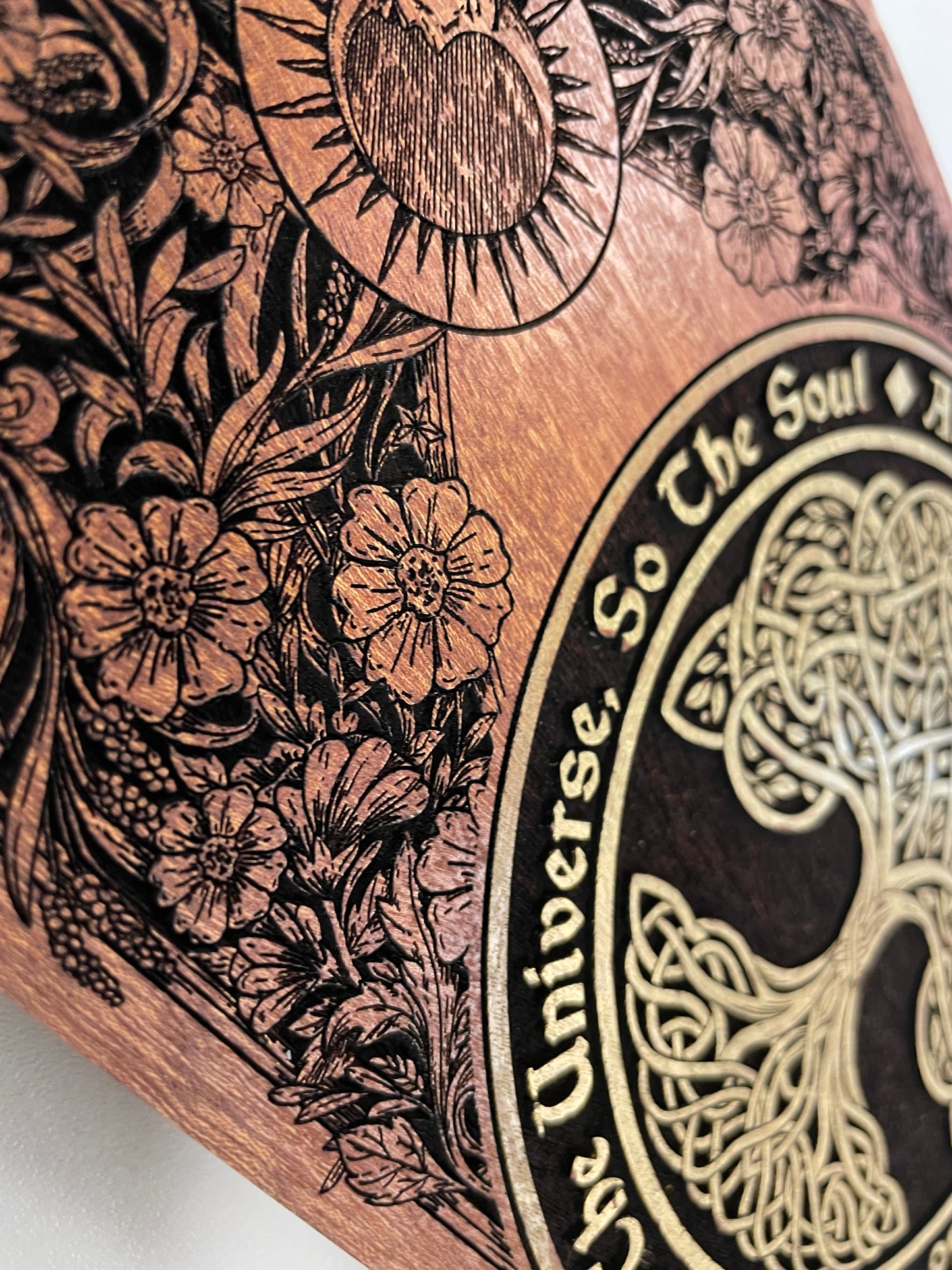 Close up of Tree of Life engraving with As Above So Below text on mahogany Wiccan ritual altar table
