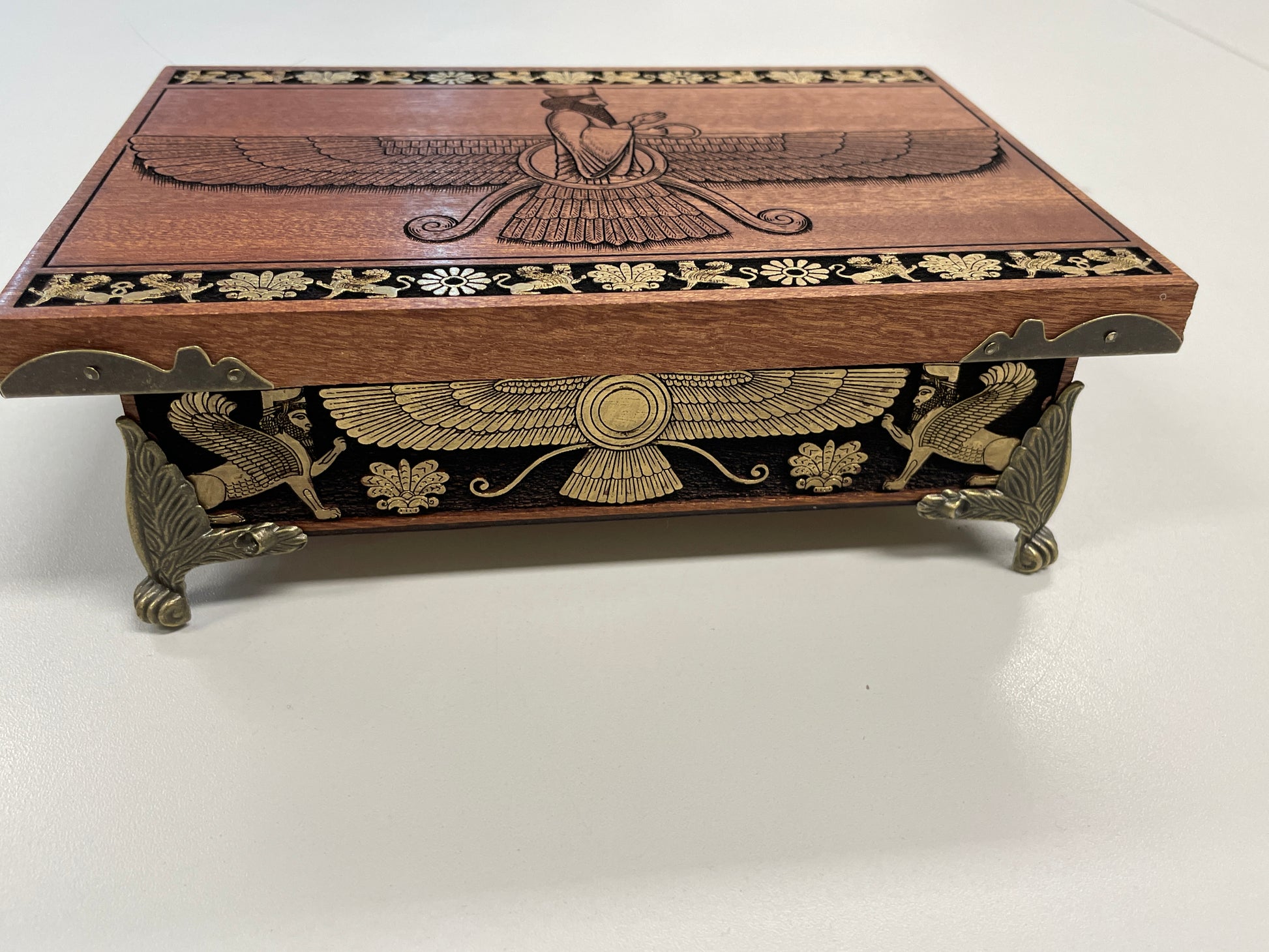 Front view  of engraved Faravahar sacred winged symbol and Zoroastrian principles on mahogany altar box