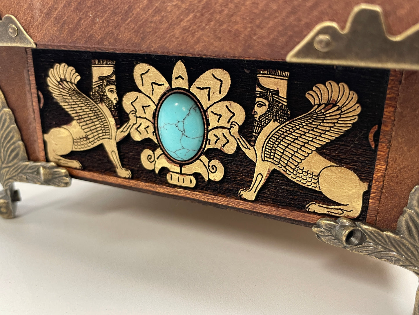 Close up of engraved Faravahar sacred winged symbol and Zoroastrian principles on mahogany altar box