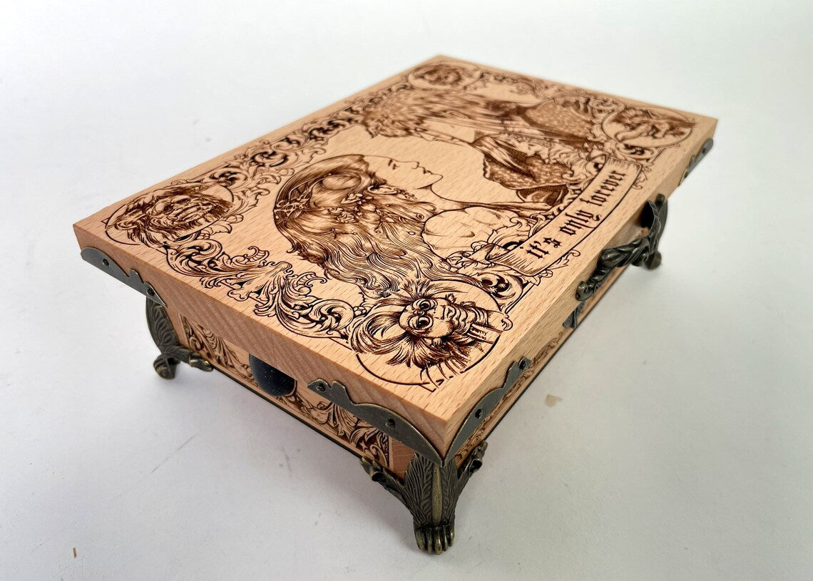 Close up of engraved Labyrinth characters on wooden musical keepsake box
