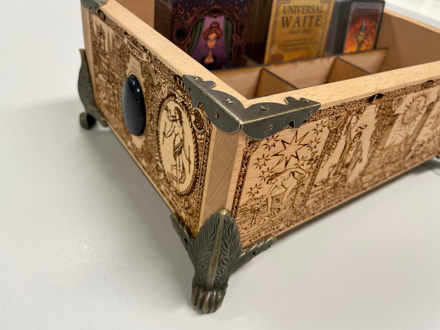 Close up of engraved tarot Major Arcana artwork on multiple deck organizer wooden box
