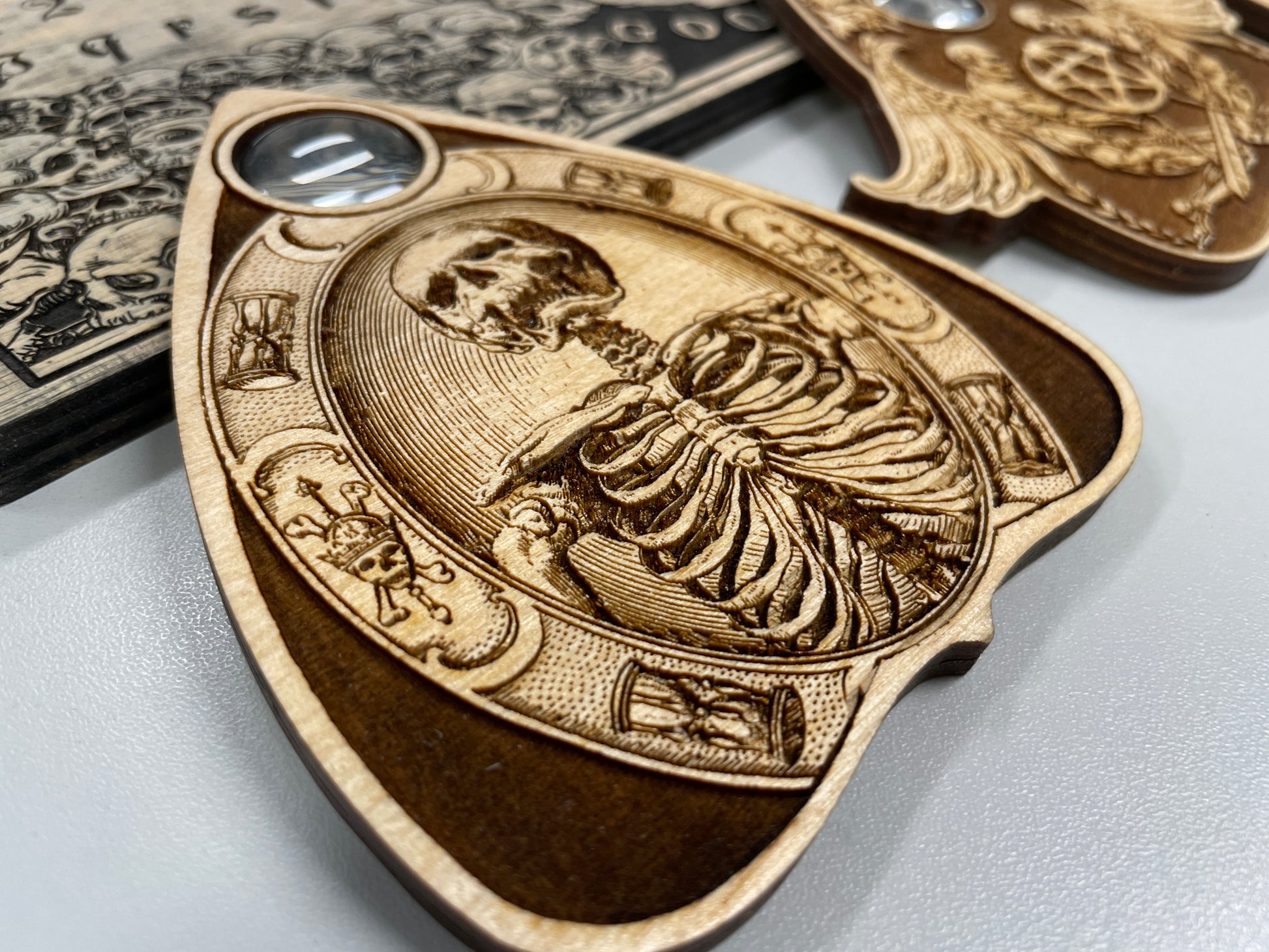 Skeleton design engraved wooden planchette with real glass viewing window
