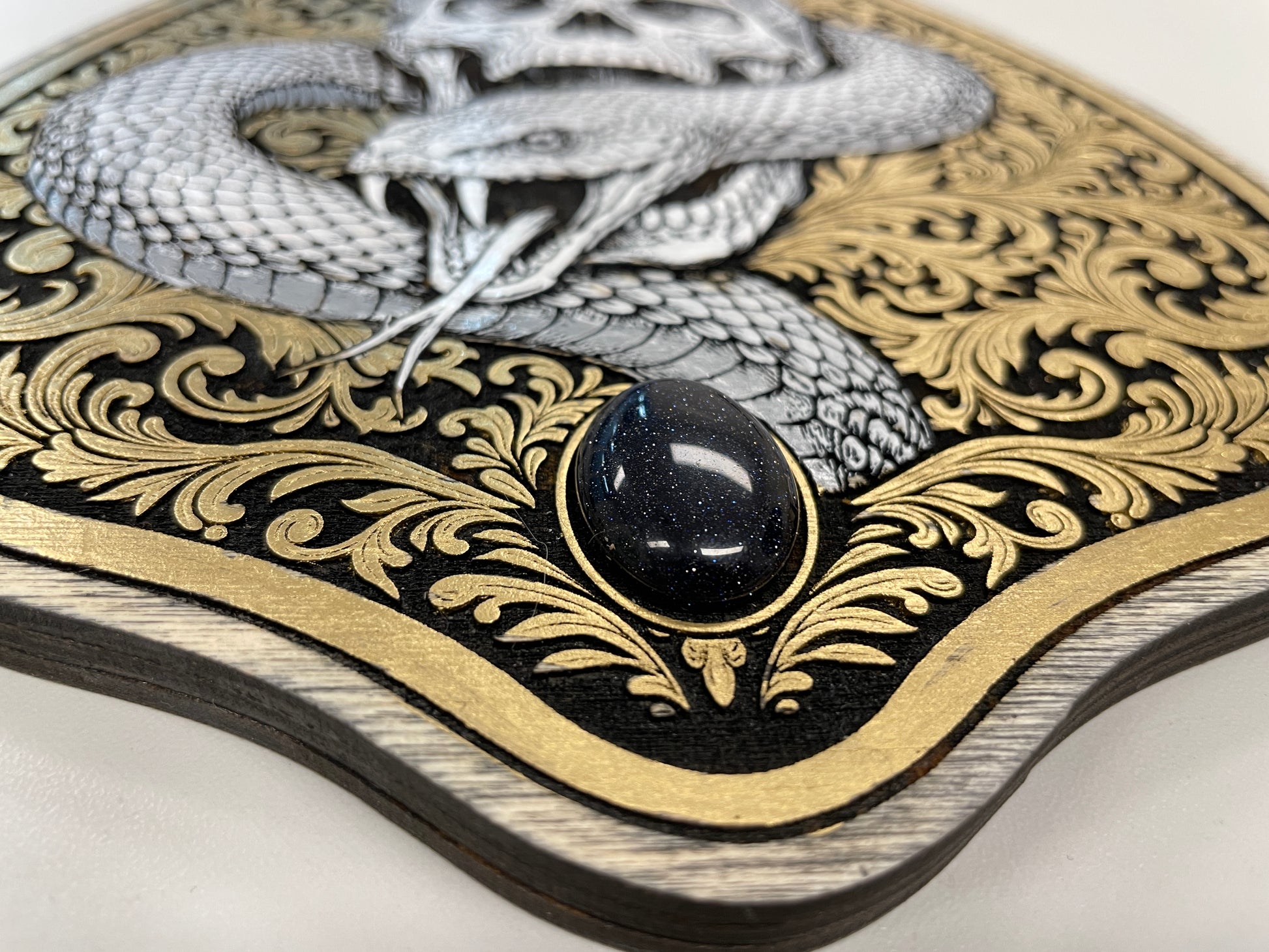 Detailed view of Gothic skull and snake Ouija planchette wall art hand painted spirit board decor