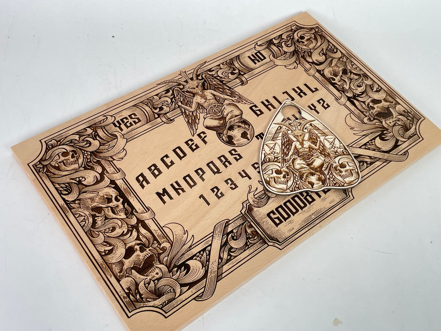 Baphomet Ouija board engraved on solid wood featuring gothic Satanic symbolism, traditional spirit board letters, numbers, and divination layout, handmade wooden altar piece for ritual and gothic decor
