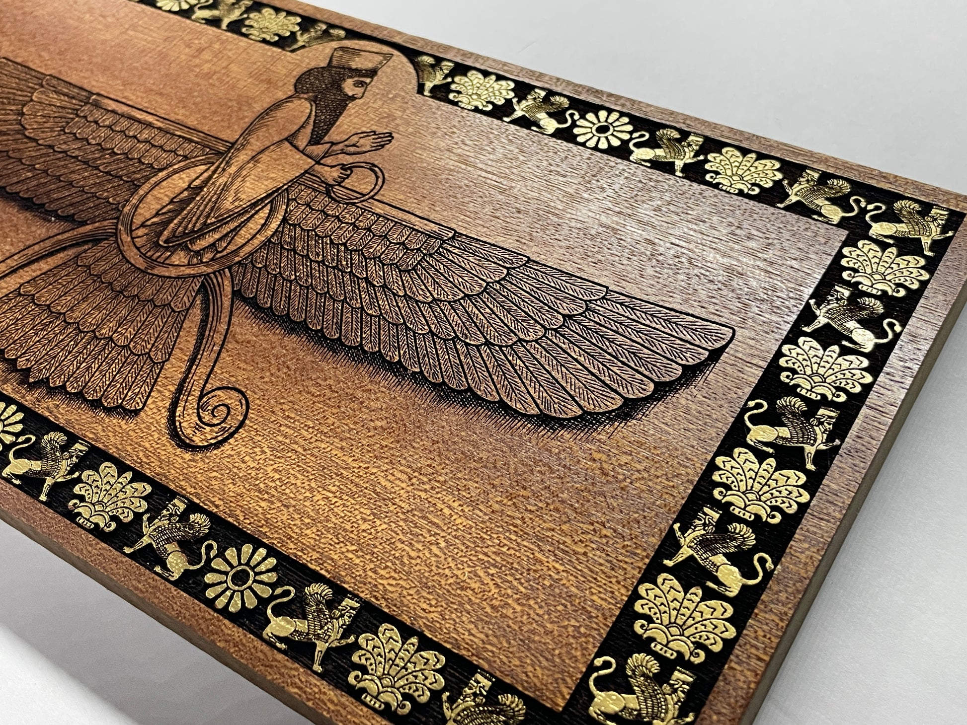 engraved Ahura Mazda Faravahar wall art in mahogany wood, Persian Zoroastrian symbol decor with rich texture and carved details
