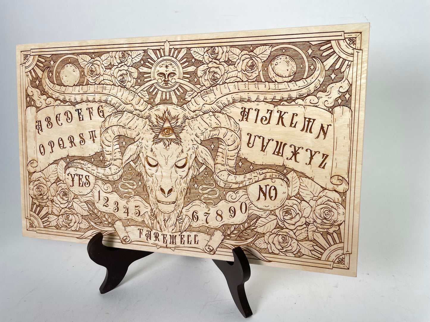 Engraved celestial Ouija board with engraved floral and solar artwork for meditation and energy practice
